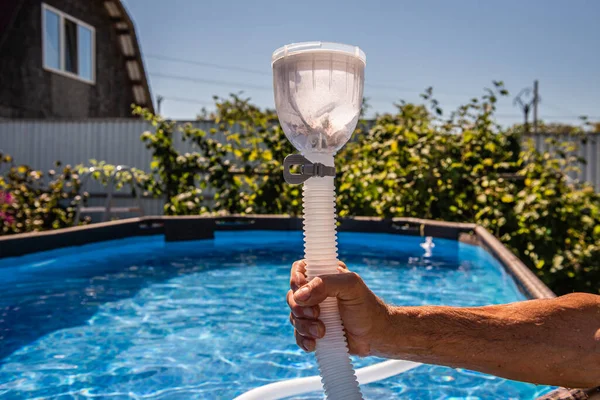 cleaning the pool with a vacuum cleaner. dirty filter after cleaning water. Cleaning equipment for small pools.