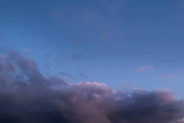 Blurred image of dark blue sky with dramatic clouds. Bad weather concept.