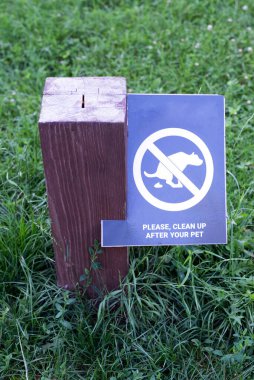 A sign asking you to clean up after your pets.The concept of rules of conduct in public places.