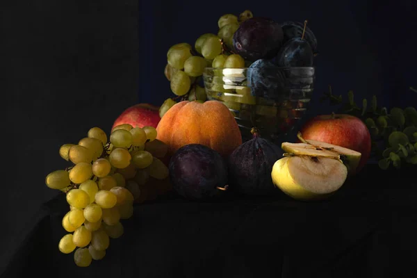 Blurred image of a still life with fruit on a dark background in the Dutch style.Fruit background.