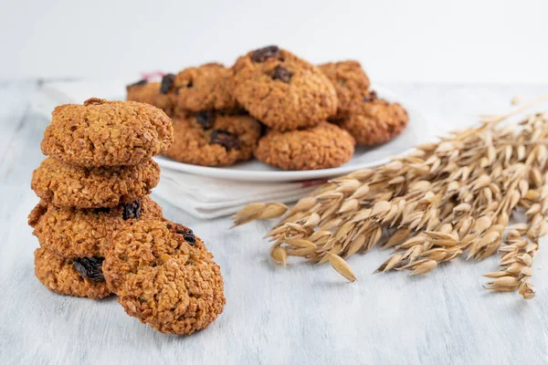 Oatmeal cookies and oatmeal spikelets on a light table. Healthy food concept.