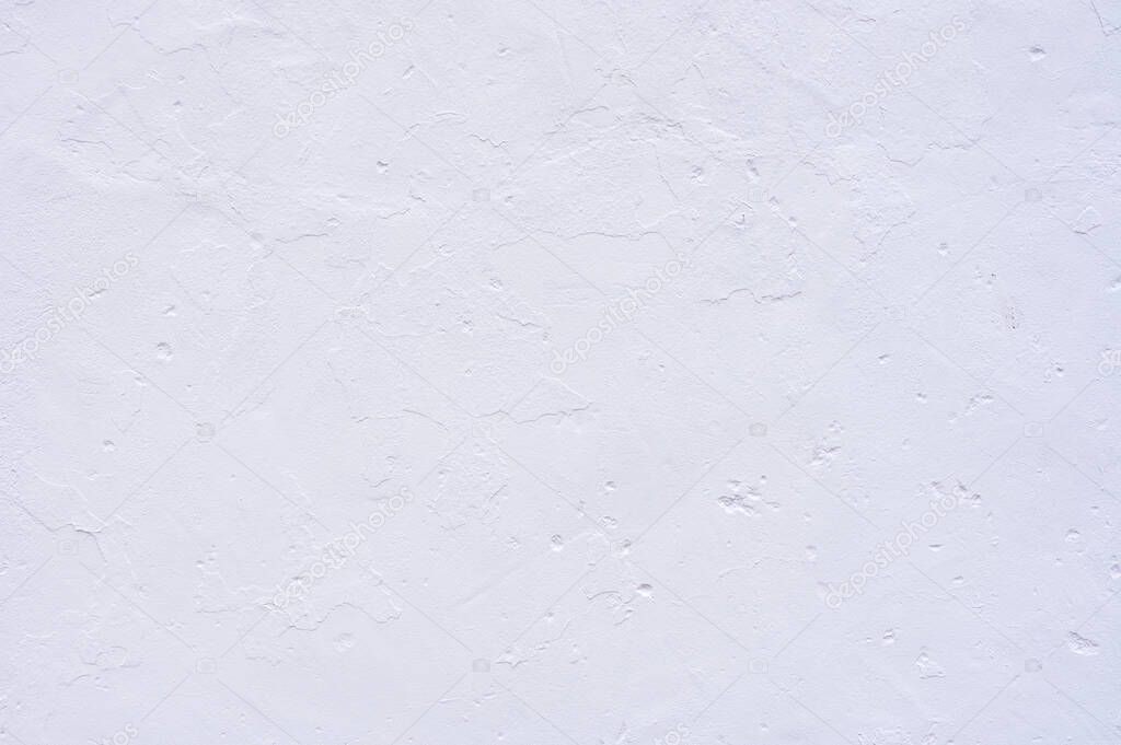 detail of a white plastered wall with a rough appearance