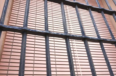 Antika bir pencerenin üzerindeki eski ve sahte bir çitin ayrıntıları.