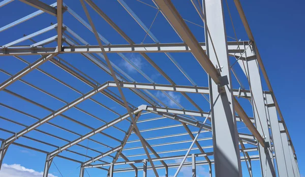 detail of the metal structure of a building or ship in the middle of the construction with blue and cloudy sky