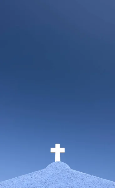 detail of a white cross on a blue wall with blue sky in the background