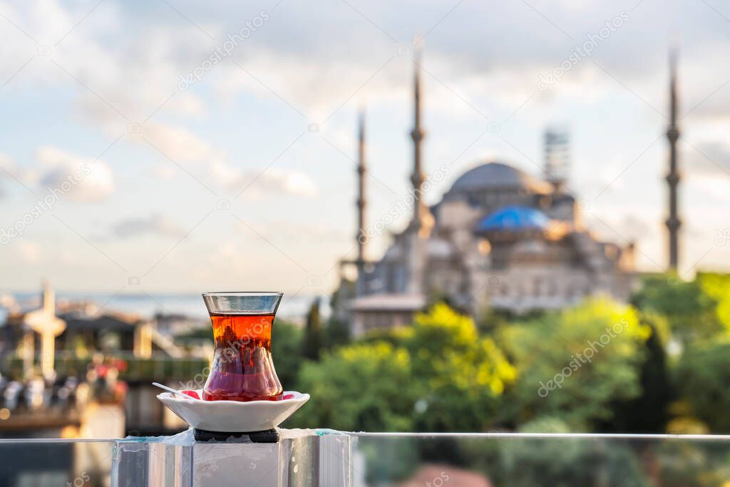 Hot black Turkish tea. Cups of Turkish tea with a saucer against the backdrop of the Hagia Sophia at dawn.