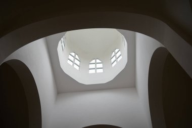 Round arch with windows under the dome of the church inside