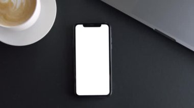 Young man hand holding a smartphone touching phone with white screen 
