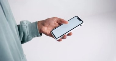 Young man hand holding a smartphone touching phone with white screen 