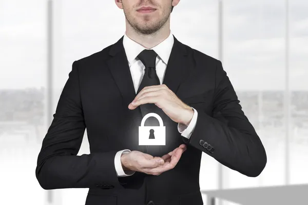 Businessman protecting lock symbol — Stok fotoğraf