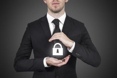 Businessman protecting lock symbol