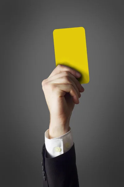 Businessman showing yellow card — Stock Photo, Image