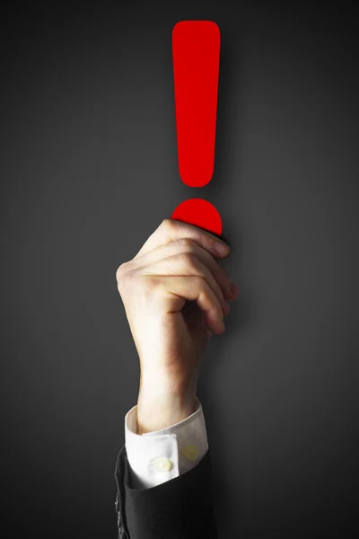 Hand holding red exclamation point — Stock Photo, Image