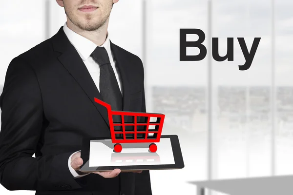 Businessman holding tablet red cart buy — Stock Photo, Image
