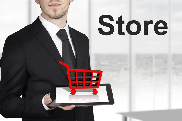 Businessman tablet shopping cart — Stock Photo, Image