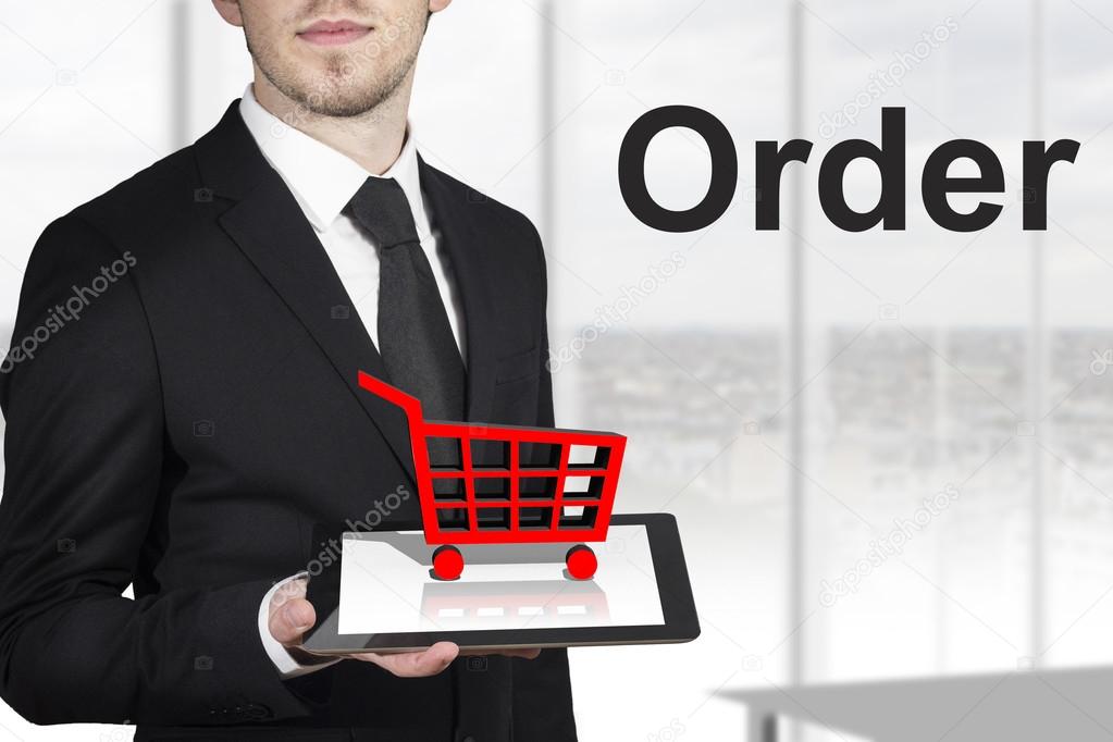 Businessman tablet shopping cart order