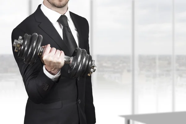 businessman weightlifting in office