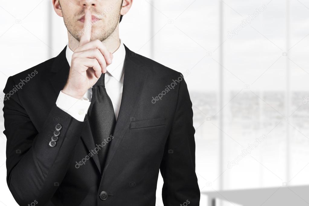 businessman silent quiet gesture