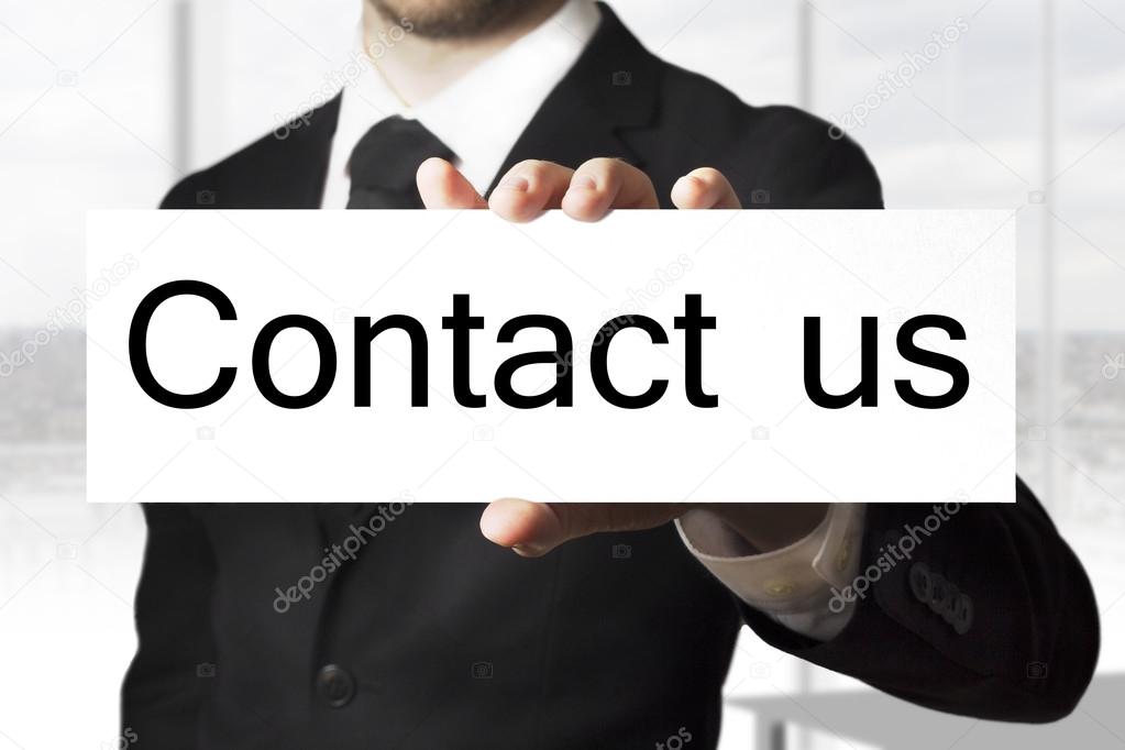 businessman holding sign contact us