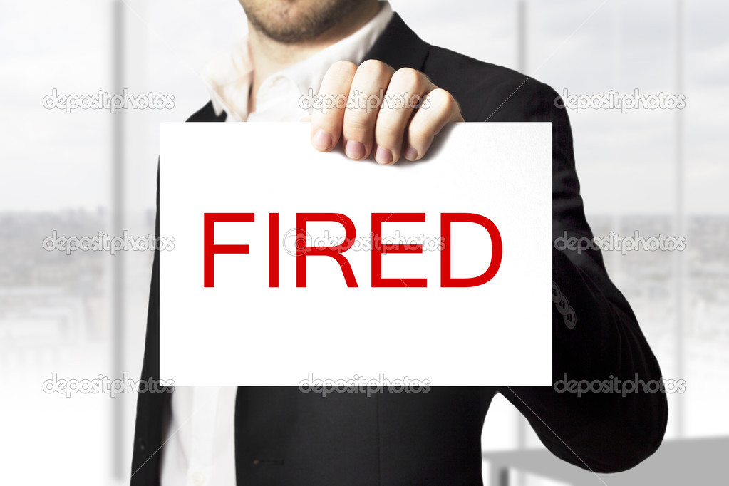 businessman holding sign fired