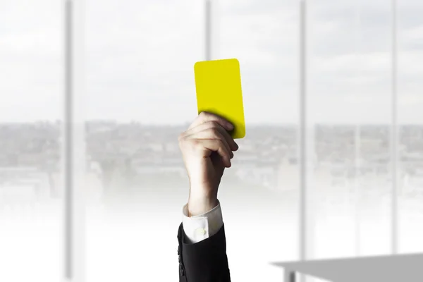 Hand showing yellow card office — Stock Photo, Image