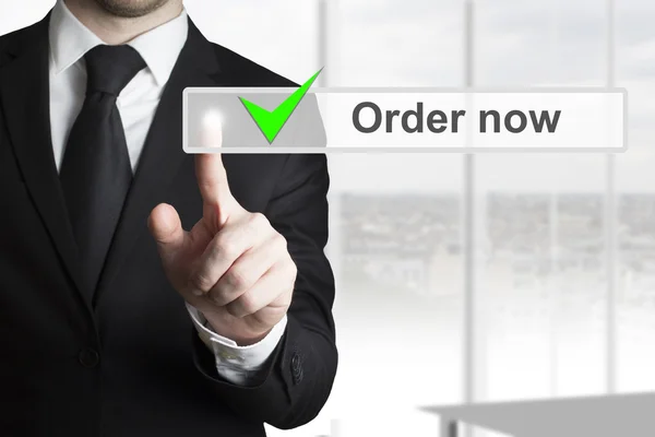 Businessman pushing touchscreen button order now — Stock Photo, Image