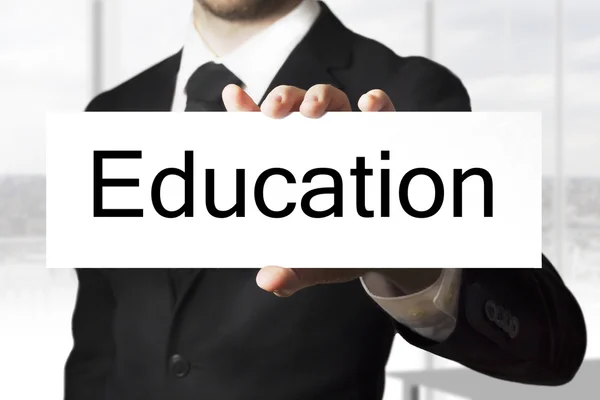 Businessman holding sign education — Stock Photo, Image