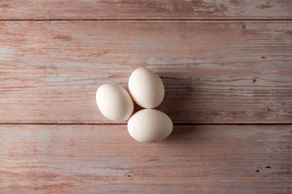 Fresh free range eggs from chicken farm on a wooden table background