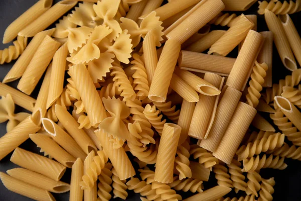 Many different types of pasta mixed together in one picture without background