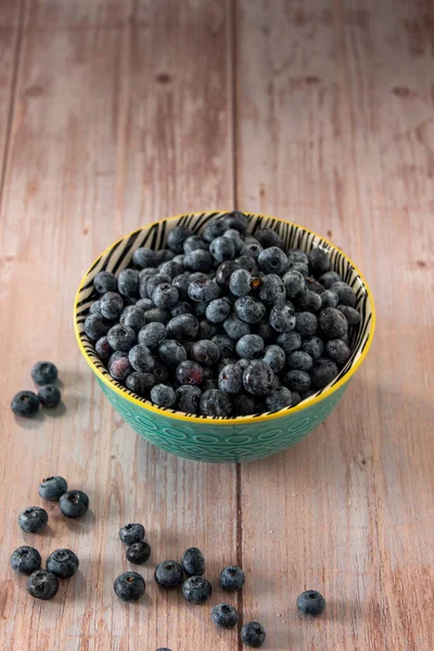 Blueberries in a beautiful bowl on a wooden table background
