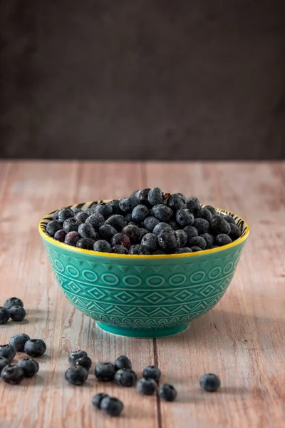 Blueberries in a beautiful bowl on a wooden table background