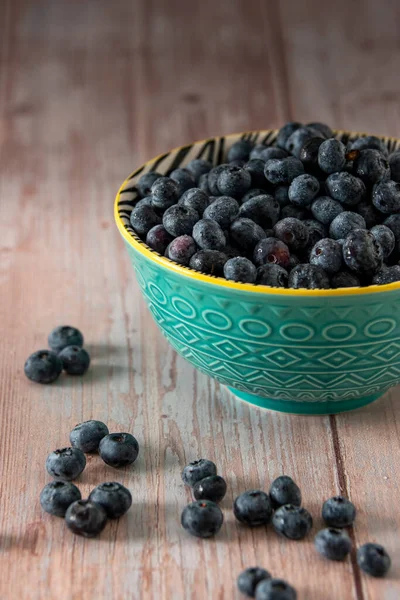 Blueberries in a beautiful bowl on a wooden table background