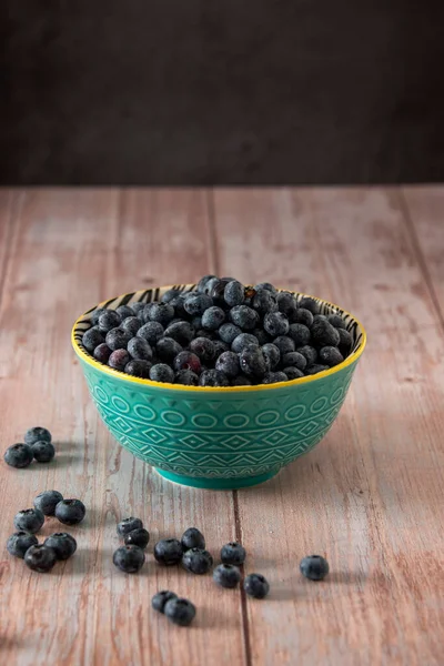 Blueberries in a beautiful bowl on a wooden table background