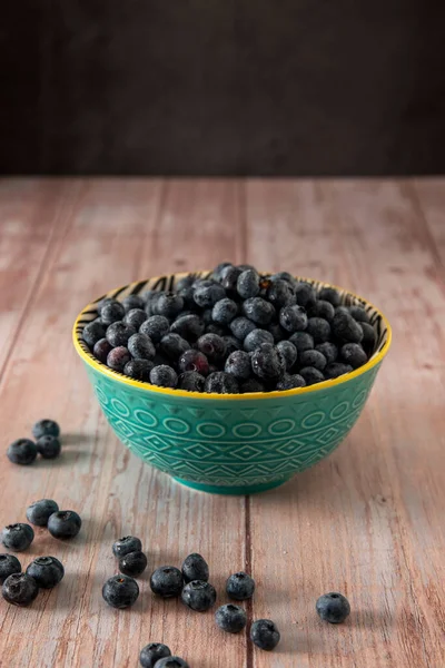 Blueberries in a beautiful bowl on a wooden table background