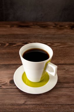 Beautiful coffee cup on a wooden table full of coffee