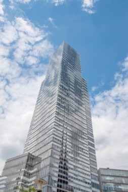 Cologne tower skyscraper at Mediapark during sunny weather with blue sky and clouds