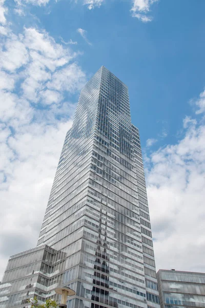 Cologne tower skyscraper at Mediapark during sunny weather with blue sky and clouds