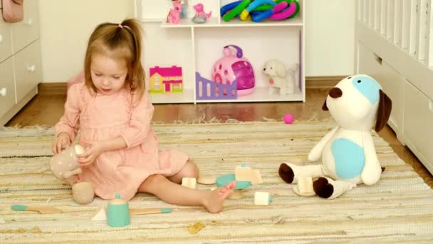 Baby Girl Plays Nursery Toy Dishes Pouring Tea Cups Her — Stockvideo