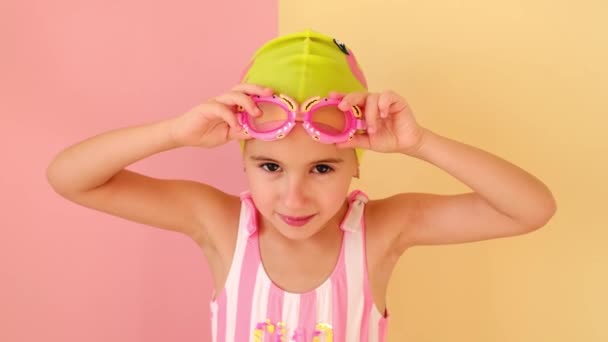 Uma Menina Boné Natação Maiô Rosa Listrado Usa Óculos Natação — Vídeo de Stock