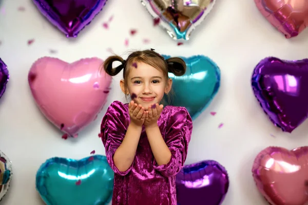 Cute Adorable Girl Blows Pink Confetti Shape Hearts Her Palms — Φωτογραφία Αρχείου