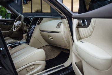 Modern luxury car Interior - steering wheel, shift lever and dashboard. Car interior luxury inside. Steering wheel, dashboard, speedometer, display.Yellow leather interior. White leather interior.