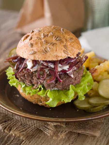 Hamburger with cucumber and onion — Stock Photo, Image
