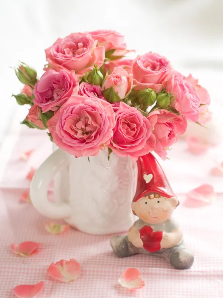 Pink roses and small dwarf — Stock Photo, Image