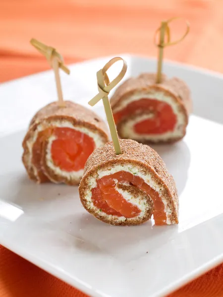 Appetizers with salmon and cheese — Stock Photo, Image