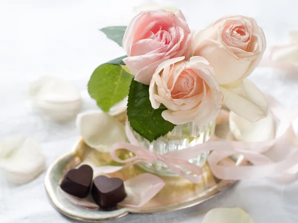 Cream roses and candies Stock Photo