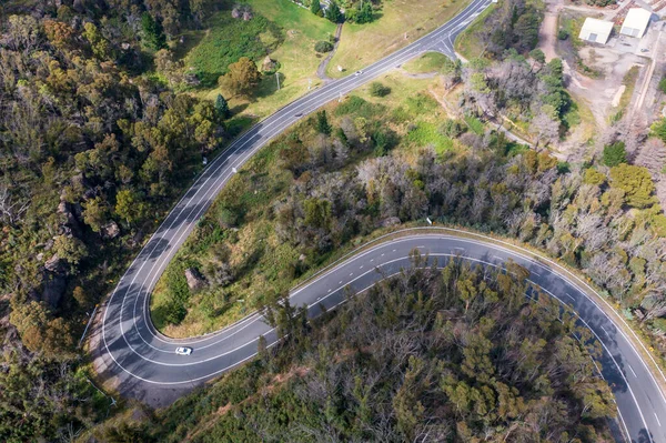 Drone aerial photograph of a highway running through a large forest in The Central Tablelands of New South Wales in Australia.