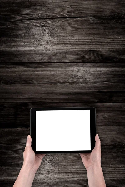 Hands hold the tablet on old table — Stock Photo, Image