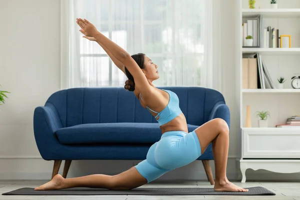 Side View Asian Woman Wearing Blue Sportwear Doing Yoga Exercise Stock Image