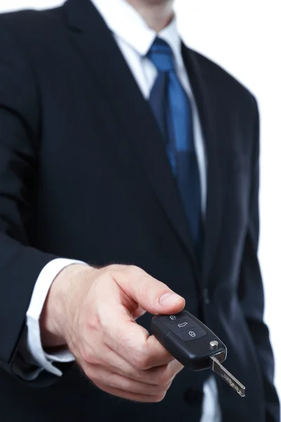 Young successful businessman offering a car key — Stock Photo, Image