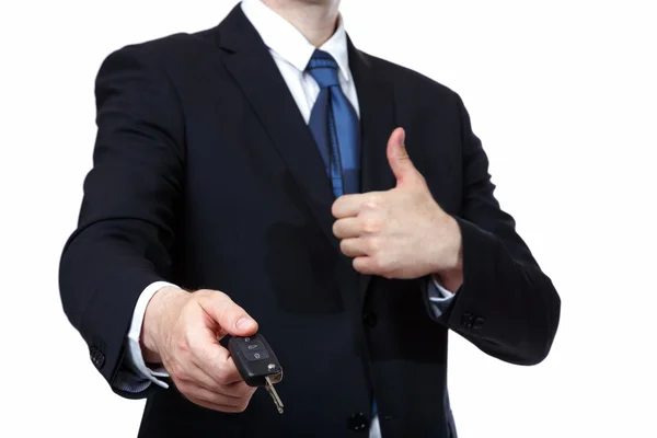 Businessman gives the keys to the car. Isolated on white — Stock Photo, Image